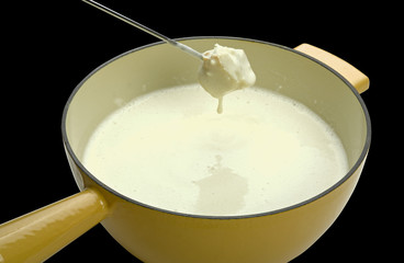 cheese fondue on black background (clipping path)