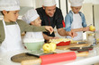© goodluz - Pastry class with kids little chefs