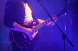 © evannovostro - Electric guitar player in blue light