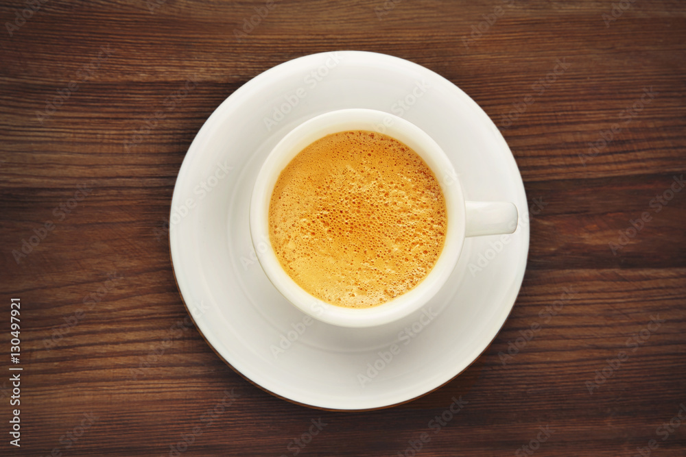 Cup of coffee on wooden background