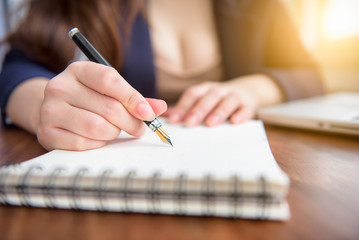 double exposure of close up business woman hand working on lapto