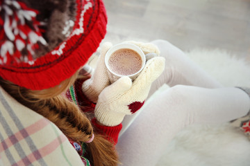 Fototapete - Beautiful young woman with cup of coffee at home, closeup