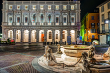 Piazza Vecchia, Citta Alta, Bergamo, Italy. Night View On The Square With The Beautiful Fountain In The Center Of The Square Illuminated By Night Lights.