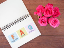 Word Spell FAQ And Pink Rose Flower On Wood Background 4