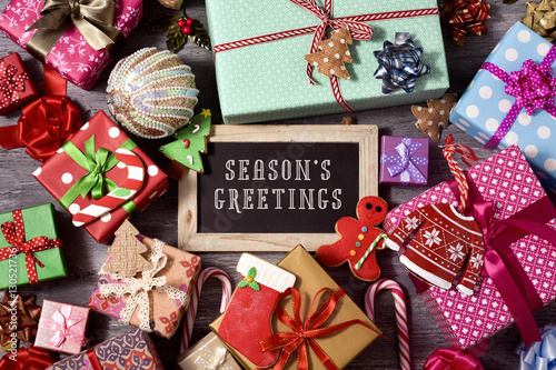 gifts, christmas ornaments and text seasons greetings плакат