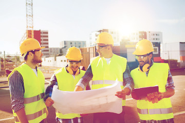 Canvas Print - group of builders with tablet pc and blueprint