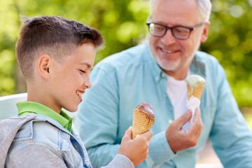 Wall Mural - old man and boy eating ice cream at summer park