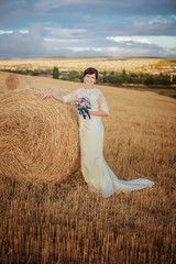 Wedding, bride and groom in nature in a haystack