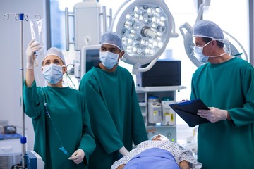 Poster - Surgeons adjusting iv drip in operation theater