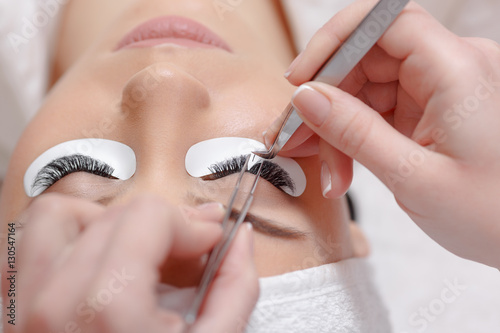 Fotografía Eyelash Extension Procedure. Woman Eye with Long Eyelashes