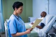 © WavebreakMediaMicro - Female nurse checking patient report in ward