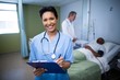 © WavebreakMediaMicro - Portrait of female nurse writing on clipboard in ward