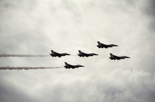 Low Angle View Of Fighter Planes In Cloudy Sky During Airshow