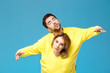 © Cookie Studio - Young beautiful couple in one yellow sweater posing smiling having fun over blue background.