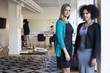 © Cavan Images - Portrait of confident multi-ethnic businesswomen at office