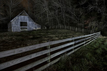 View Of Barn On Field In Forest At Night