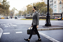 Side View Of Businessman Crossing Road In City