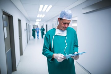 Poster - Surgeon checking report in corridor