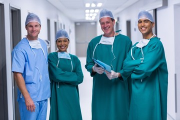 Poster - Portrait of nurse and surgeons standing in corridor