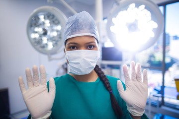 Poster - Surgeon wearing surgical gloves in operation theater