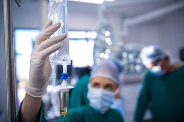 Poster - Female surgeons adjusting iv drip in operation theater