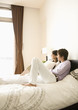 © imagenavi - Couple relaxing on bed