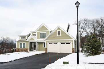 house in residential area after snow