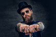 © Fxquadro - Close up tattooed hipster's fingers with rings.