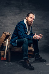 Full body portrait of bearded male wearing a denim jacket.