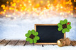 2017 Silvester new years eve bokeh background with champagne cork empty blackboard decorated with four leaf clover and ladybug