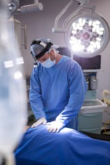 Poster - Surgeon examining a patient in operation room