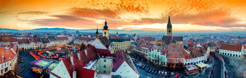 Panoramic view of Sibiu central square in Transylvania, Romania. City also known as Hermannstadt. Sunset HDR hi-resolution photography. - obrazy, fototapety, plakaty 