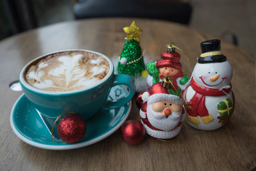 Christmas day and new year Santa Claus hot coffee heart foam on wooden table day time / Christmas coffee