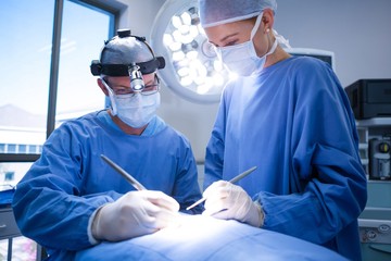 Poster - Surgeons performing operation in operation theater