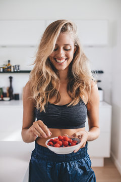 Smiling woman having healthy breakfast at home