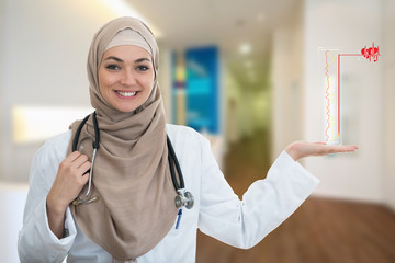 Wall Mural - Closeup portrait of friendly, smiling confident Muslim female doctor holding medical symbols