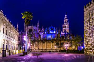 Wall Mural - night view of the illuminated cathedral in sevilla