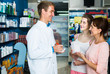© JackF - portrait of man druggist in white coat giving advice to customer