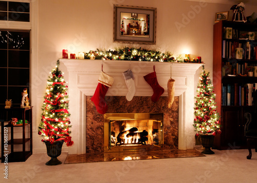 Living room decked out for the Christmas holidays with trees, stockings and a wa Tableau sur Toile