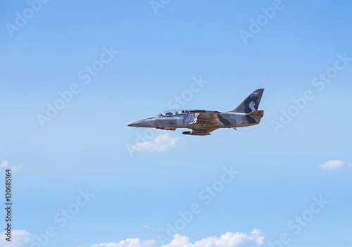 Fotografie, Obraz L-39 albatros fighter jet flying on sunset background on white blue sky backgr