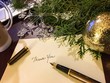 Writing Holiday Greeting and Thank You Cards on Desk with Coffee Fountain Pen and Christmas Ornaments