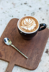 cappuccino cup on top old wood