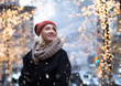 Young attractive woman with holiday background in cold snowy day
