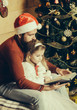 © Volodymyr - christmas bearded father and girl reading