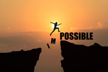 Man Jumping Over Impossible Or Possible Over Cliff On Sunset Background,Business Concept Idea