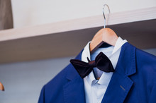 Close-up Of Blue Jacket With Bow Tie On A Hanger.
