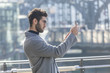 © Westend61 - Young businessman taking picture with smartphone