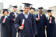 © Syda Productions - happy students in mortar boards with diplomas