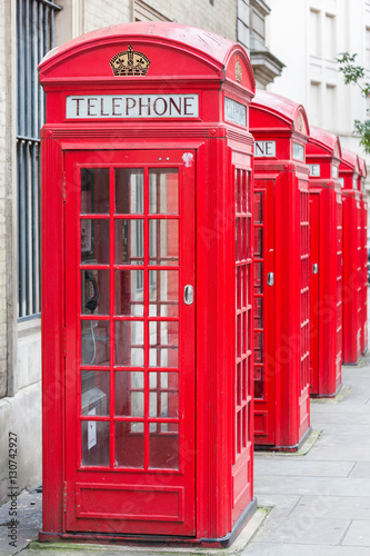 Fototapeta na wymiar Five Red London Telephone boxes all in a row