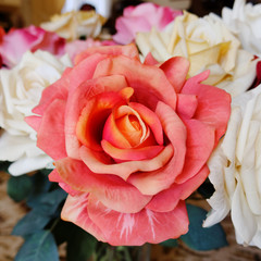 colorful orange fake rose flower closeup